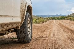 close up of car tire on dirt road